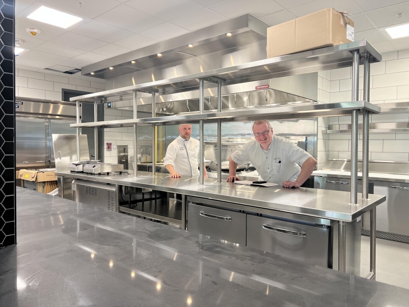 Scott Bruhn, culinary director, and Dave Huppert, executive chef for research and development explore a new dining venue in the John Lewis Student Center.